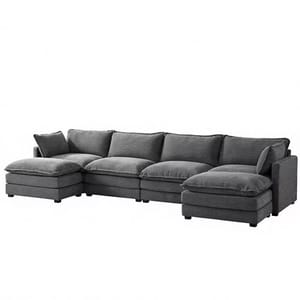 A gray sectional sofa with multiple cushions, featuring a chaise on each end for added seating and comfort.
