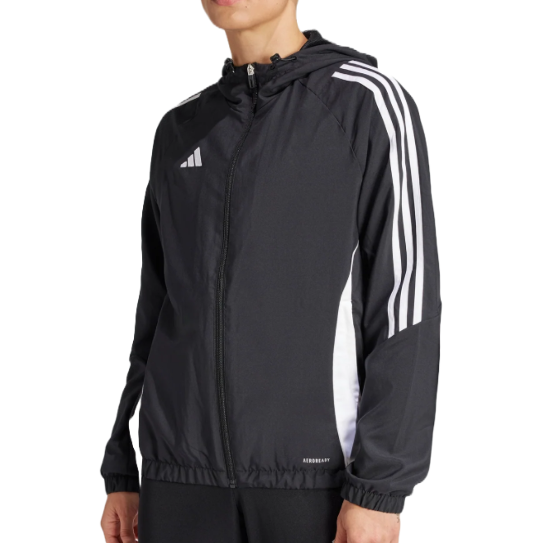 A black Adidas jacket featuring white stripes on the sleeves, a hood, and a front zipper. The hem and cuffs are elasticated.