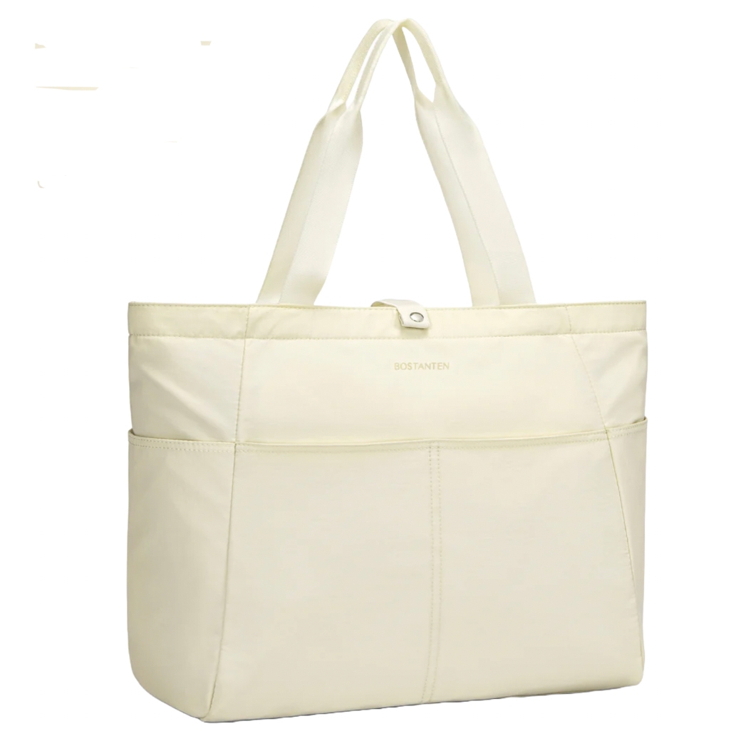 A cream-colored, foldable tote bag with 13 pockets, featuring two sturdy handles and a button closure. The design is simple and functional, suitable for carrying various items.