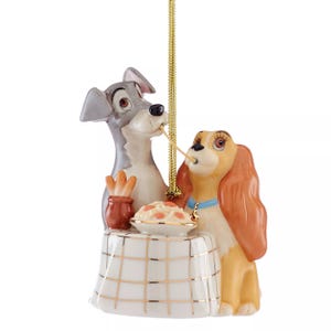 Ornament featuring two dogs sharing a spaghetti noodle at a table, inspired by a romantic scene from a classic animated film.