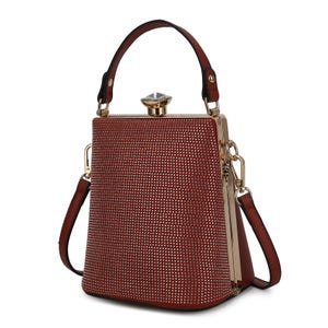 A brown handbag with a structured trapezoid shape, featuring a top handle, detachable shoulder strap, and gold clasp adorned with a crystal accent.