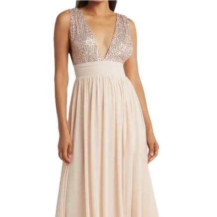 A woman is wearing a V-plunge maxi dress with a sequined top and a flowing, light-colored skirt.