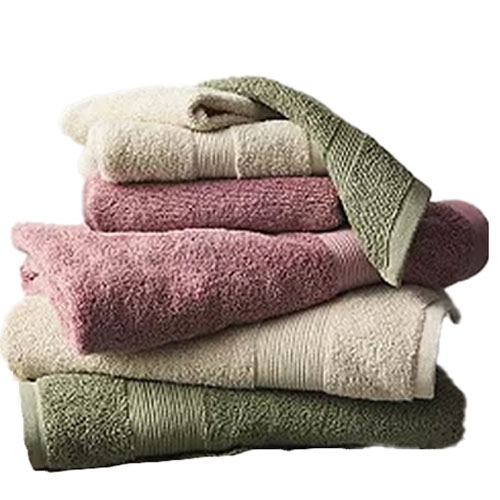 A stack of folded towels in green, beige, and pink shades.