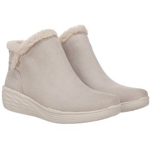 Cream-colored ankle-height booties with a faux fur trim, featuring a textured sole for added grip.