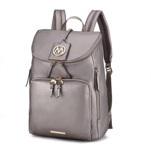 A grey leather backpack with gold-tone hardware, front zip pocket, side zip pockets, and padded straps. Features a prominent \“M\“ logo on the flap.