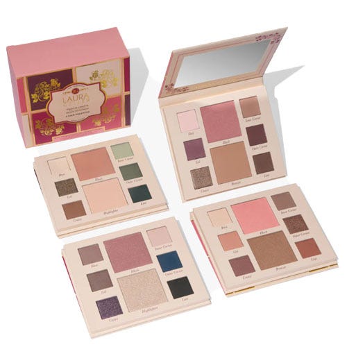 four Laura Geller makeup palettes and a pink box