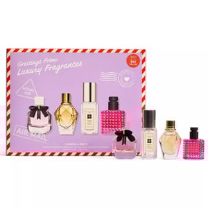Fragrance gift set featuring four mini luxury perfumes displayed in front of packaging labeled \“Greetings From: Luxury Fragrances\“ with a $50 price tag and $65 value.