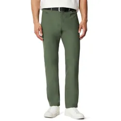A man is wearing green chinos with a black belt and white sneakers, paired with a white shirt.