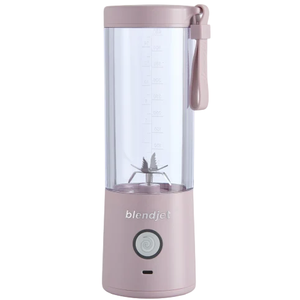 A portable, rechargeable BlendJet blender in light pink with a clear blending chamber, blade assembly, and a lanyard for easy carrying.