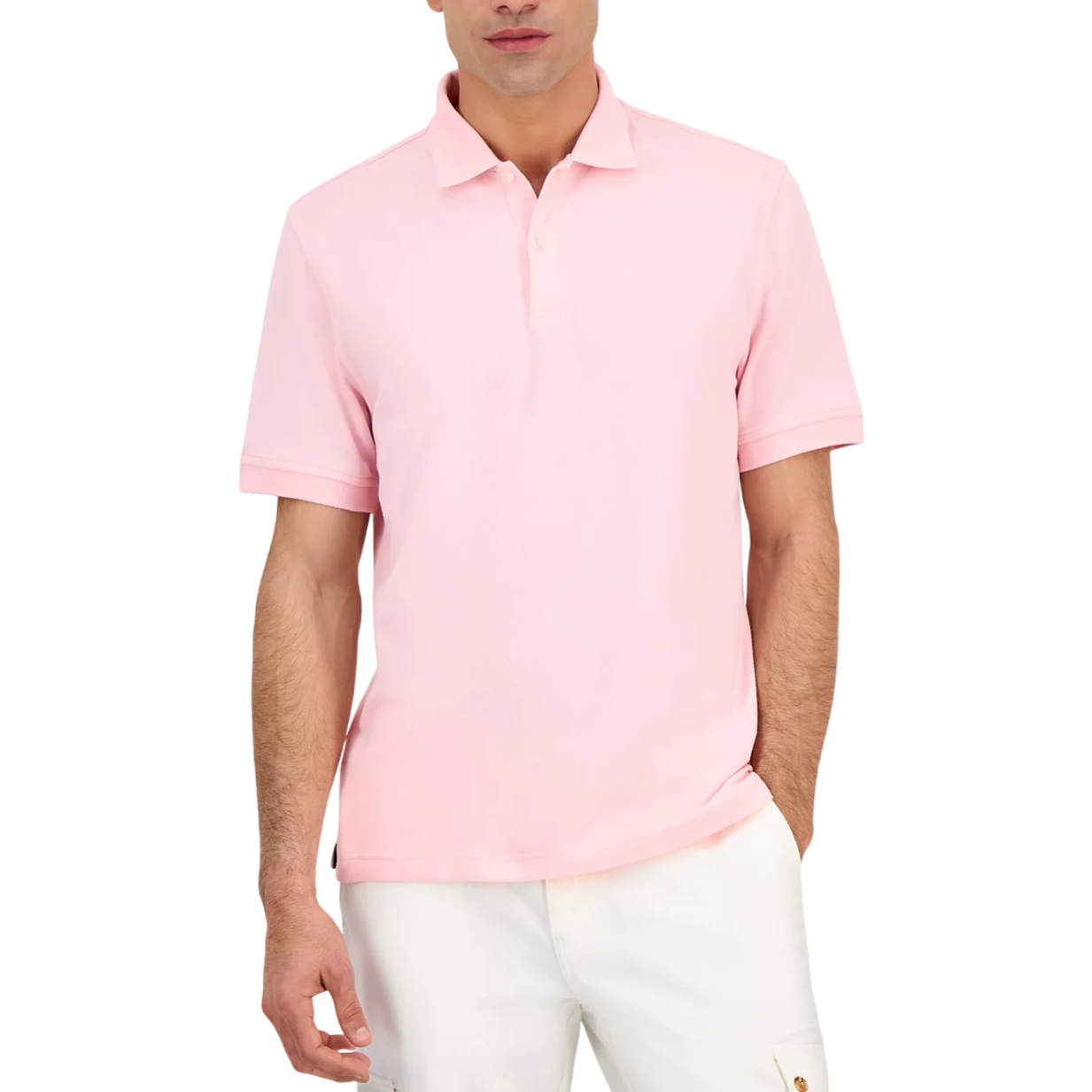 A man wears a light pink short-sleeve polo shirt paired with white pants.