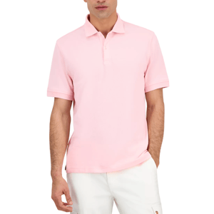 A man wears a light pink short-sleeve polo shirt paired with white pants.