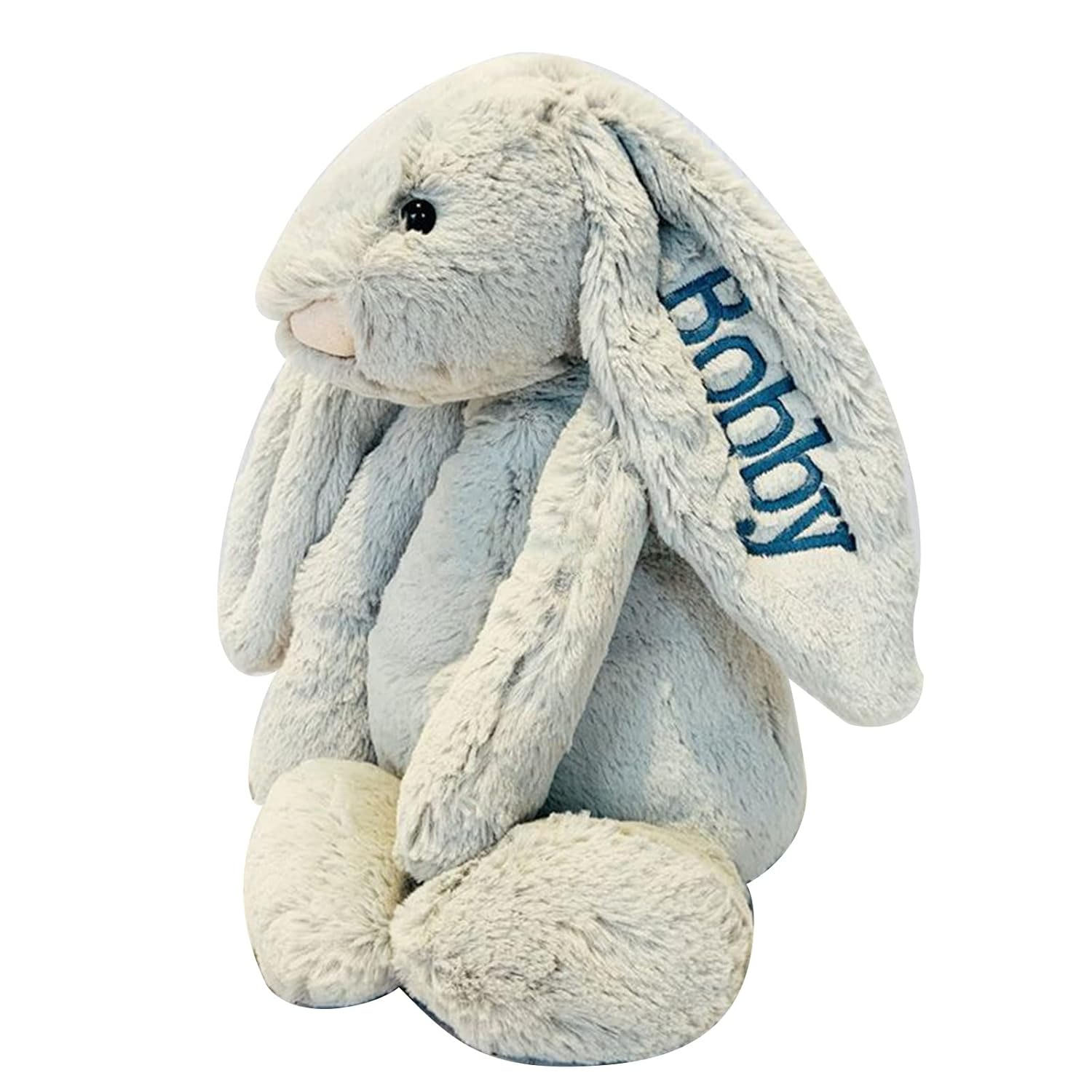 A soft, gray plush Easter bunny with long ears, one of which is embroidered with the name \“Bobby\“ in blue.
