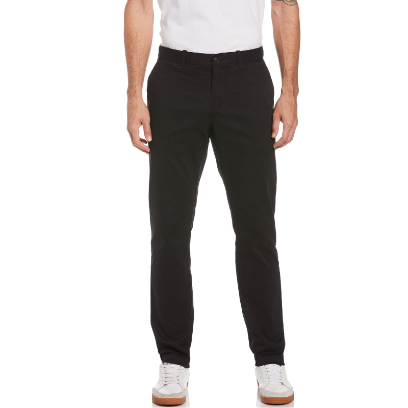 A person is wearing black pants paired with a white shirt and white sneakers.