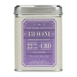 The item is a tin of \“Boom\“ tea elixirs by The Hemp Division, featuring a chocolate and coconut flavor with 22 mg CBD per serving from N.Y. grown hemp extract, containing eight sachets.