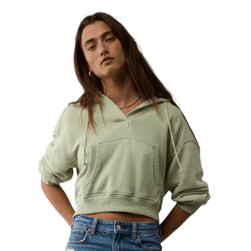 Pale green, cropped hoodie with a front pocket and drawstring hood, styled with casual denim.