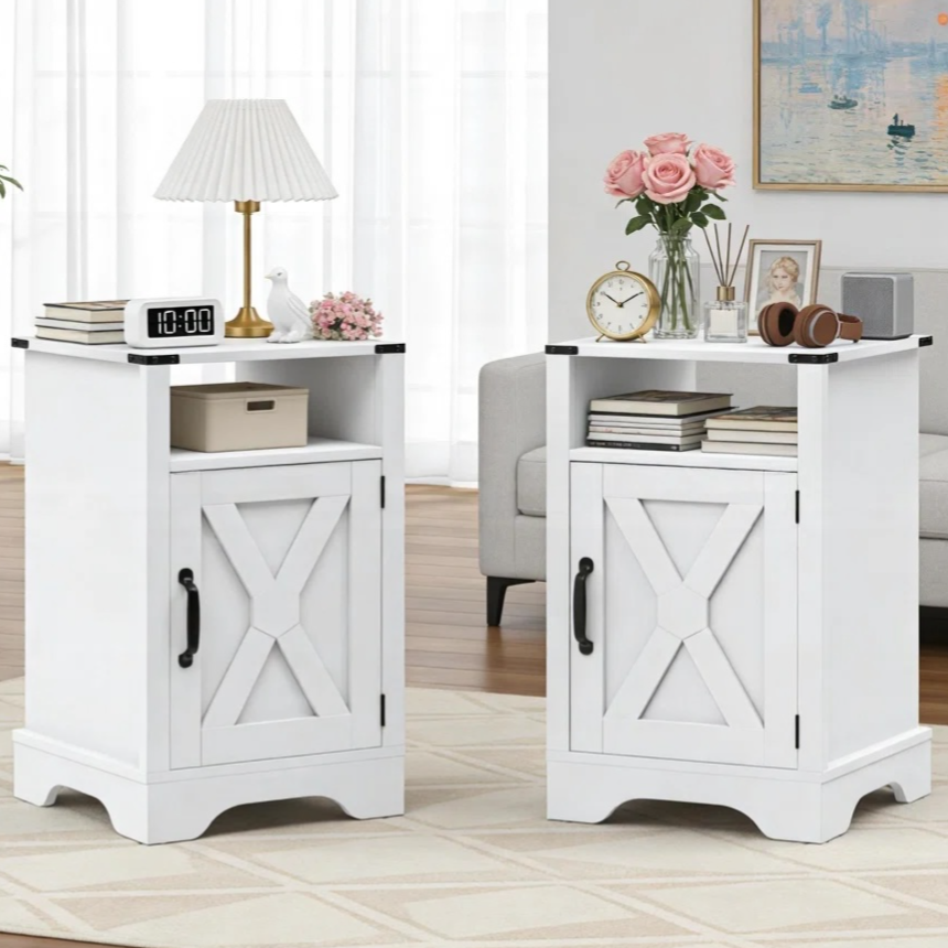 Two white farmhouse-style side tables with X-patterned cabinet doors are shown. One is topped with a lamp and digital clock, the other with a clock and books, and both have floral accents.