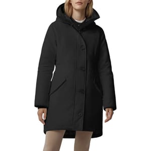 A black hooded winter coat with long sleeves and button closure, worn by a model.