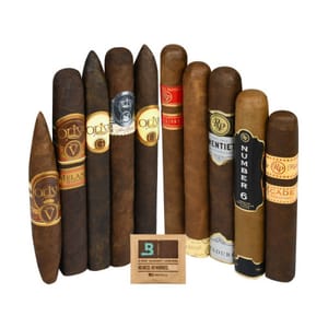 A selection of premium cigars displayed upright, featuring various labels and designs, including brands like Oliva and Rocky Patel. A humidity control packet is positioned in front.