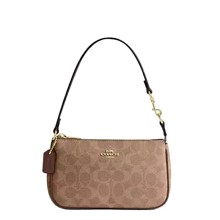 A Coach wristlet in light brown with the signature \“C\“ pattern and gold-tone hardware, featuring a detachable strap and a small tag.