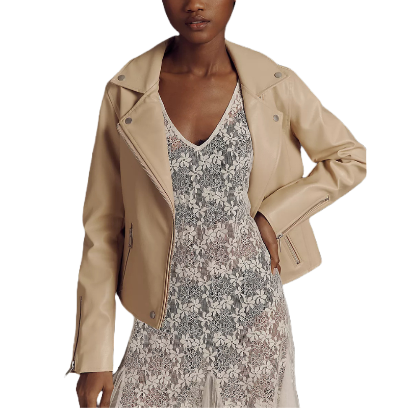 A woman is wearing a beige leather jacket over a sheer, floral lace dress.