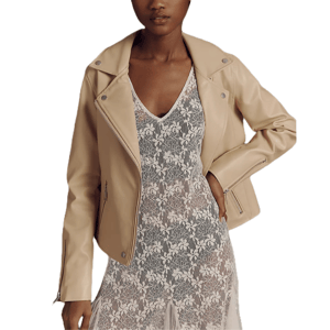 A woman is wearing a beige leather jacket over a sheer, floral lace dress.
