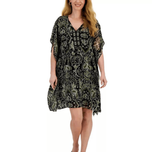 A woman is wearing a knee-length, patterned dress with a V-neck and flowing sleeves.