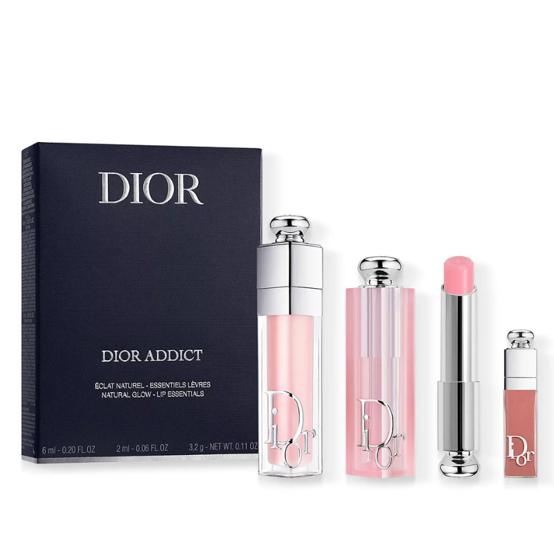 Dior Addict 3pc set includes a lip gloss, balm, and plumping gloss, all in shades of pink. Packaged in sleek tubes with silver accents, ideal for a natural glow effect.