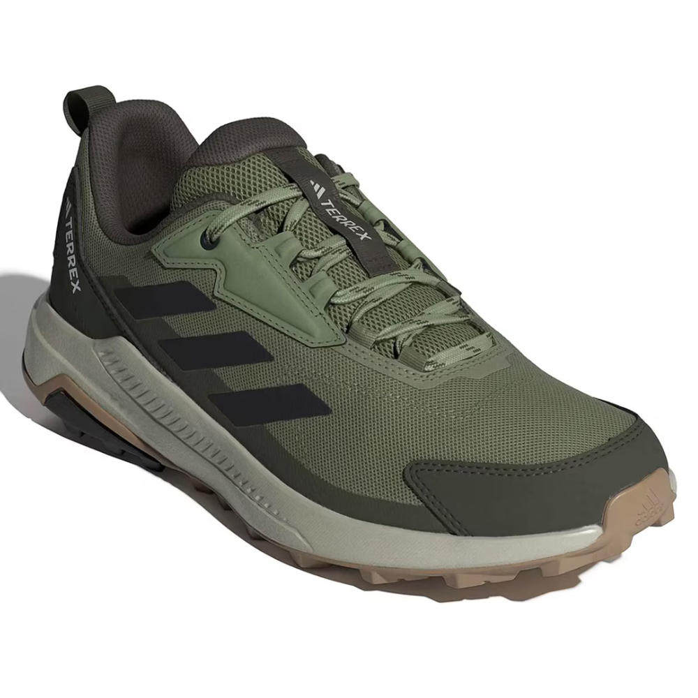 A green Adidas Terrex trail running shoe with black stripes, featuring a rugged design and durable grip for outdoor activities.