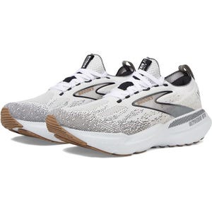 White and black running shoes with a cushioned sole and textured pattern, featuring the Brooks logo on the side.