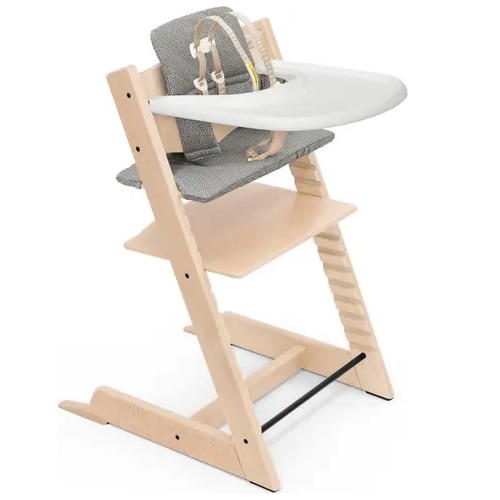 Wooden high chair with adjustable seat and footplate, equipped with a grey cushion and safety harness.