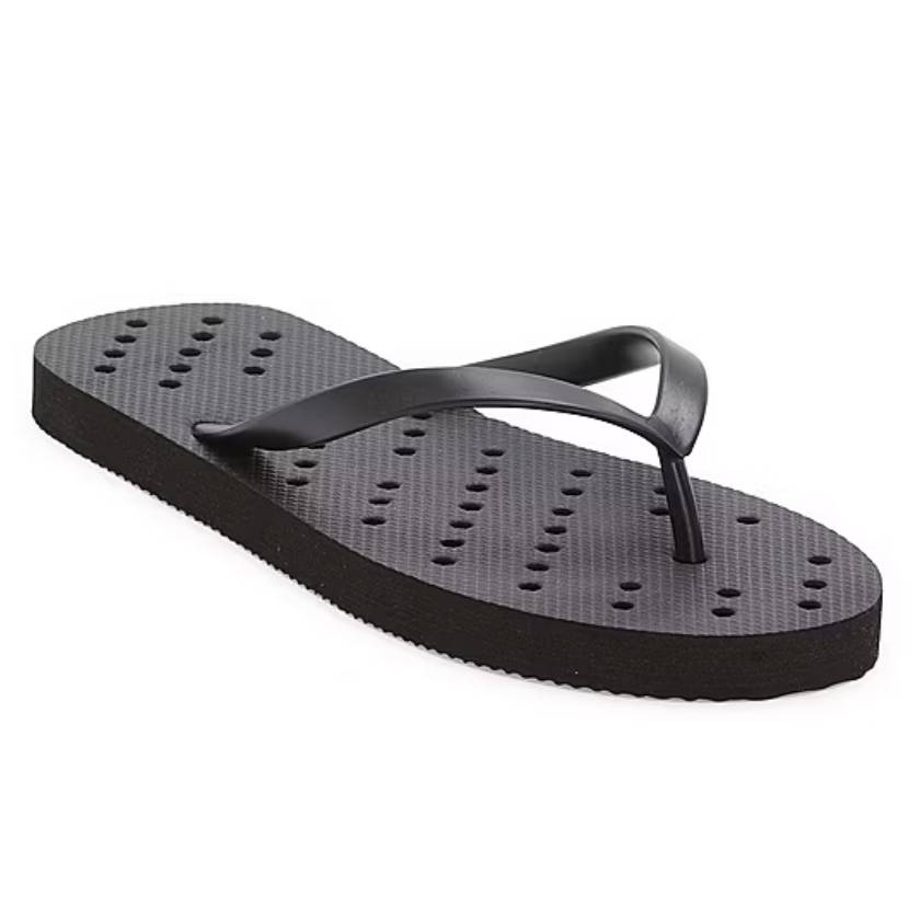 A single black flip-flop with raised dots on the footbed for grip.