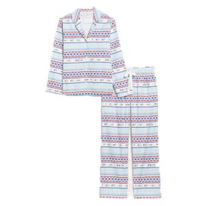 A two-piece pajama set with a top and pants featuring a festive pattern with horizontal stripes of blue, red, and white and text reading \“Merry\“ and \“Joy\“ in a repeating design.