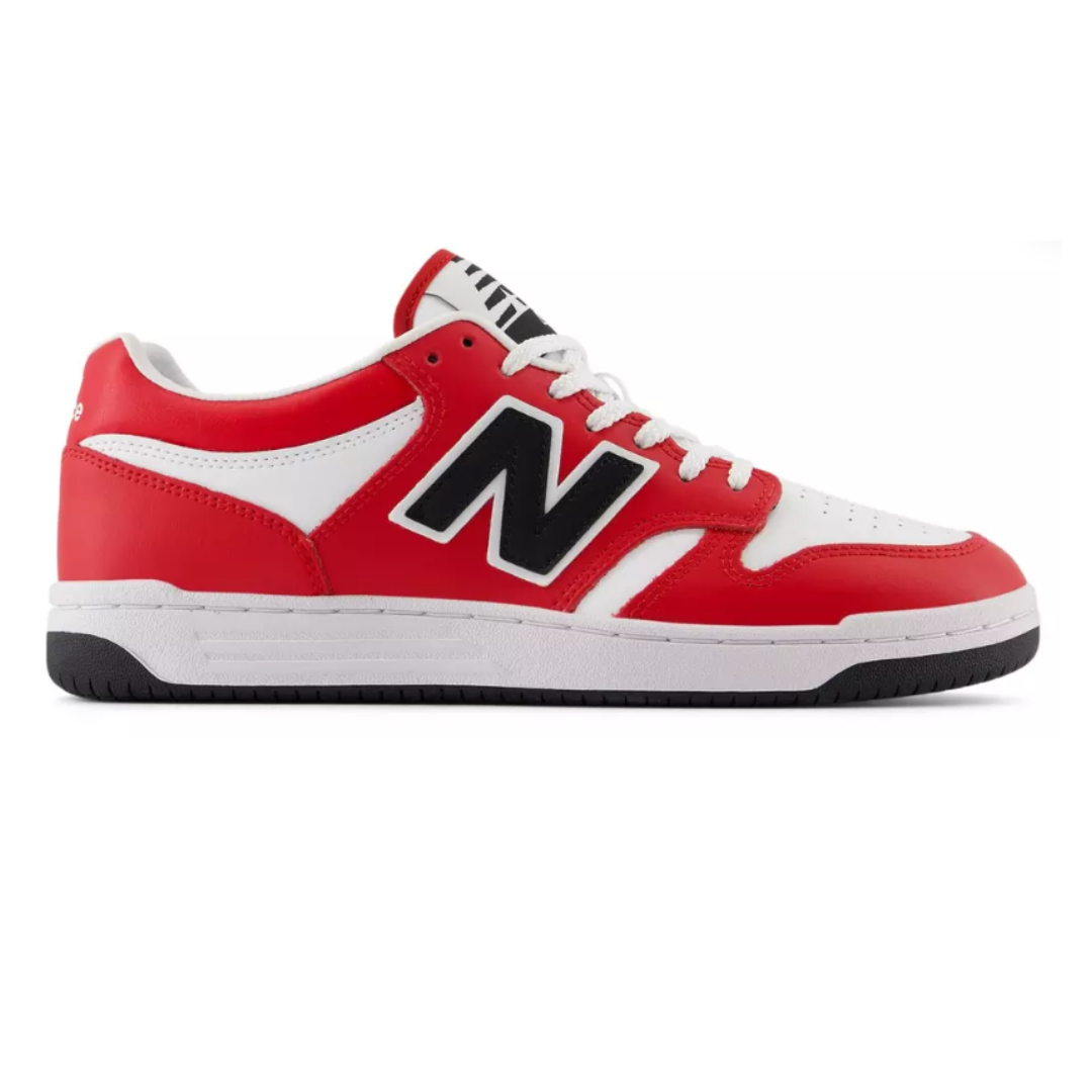 Red and white New Balance sneaker with black \“N\“ logo, featuring black and white sole and white laces.