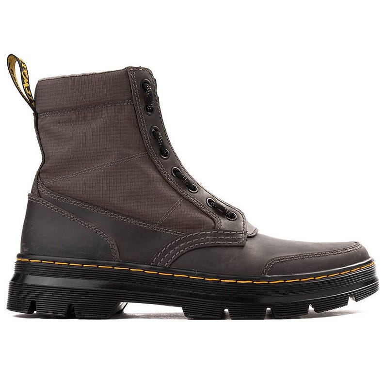 A rugged high-top lace-up boot with black and brown tones, featuring a thick sole, yellow stitching, and a fabric pull loop.