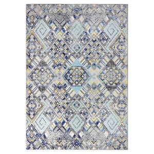 A patterned rug featuring intricate geometric designs with a color palette of blue, gray, yellow, and white. The motifs include spirals and diamond shapes arranged in a symmetrical layout.