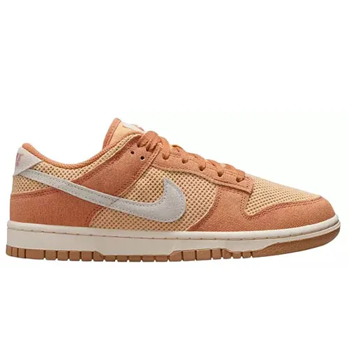A Nike Dunk Low sneaker in shades of peach and orange with a light gray swoosh, featuring a textured design and a rubber sole.