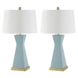 A pair of blue ceramic table lamps with white drum shades, featuring a geometric base and gold accents.