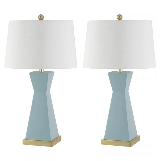 A pair of blue ceramic table lamps with white drum shades, featuring a geometric base and gold accents.