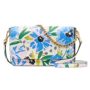 A floral-patterned handbag with blue and pink flowers, featuring a chain strap and a smooth leather finish.