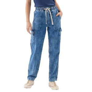 Mid-rise blue denim cargo jeans with a straight fit, featuring large front pockets, drawstring waist, and side cargo pockets. Paired with beige sneakers.