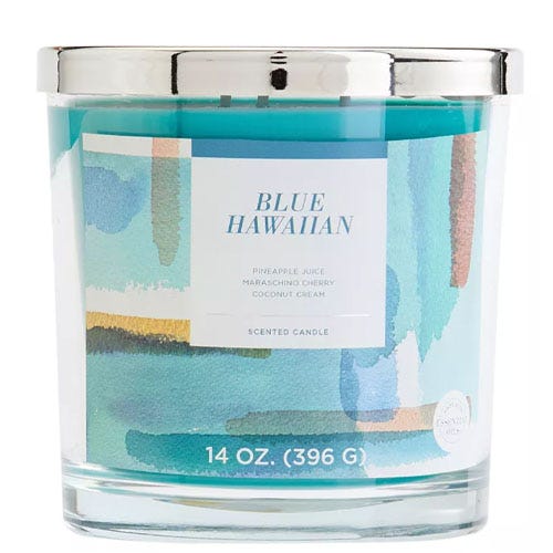 Scented candle labeled \“Blue Hawaiian\“ with notes of pineapple juice, maraschino cherry, and coconut cream, weighing 14 oz (396 g), in a glass jar with a colorful abstract label and silver lid.