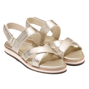 Gold metallic sandals with criss-cross straps and a small platform sole.