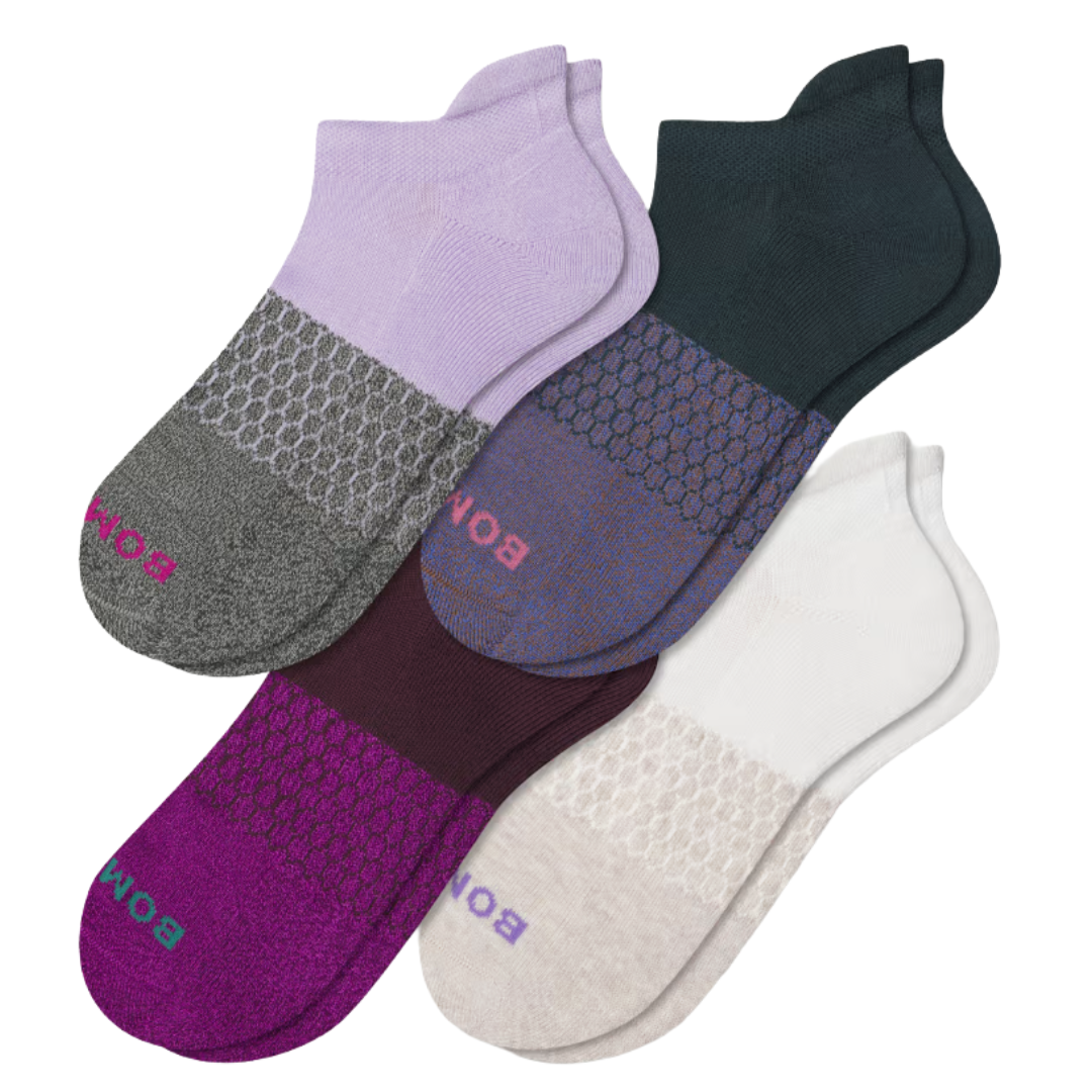 Four pairs of low-cut socks in assorted colors, each with a honeycomb pattern on the midfoot and branding near the toe. Colors include purple, dark green, maroon, and white.