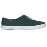 A dark green canvas sneaker with white laces and a white rubber sole, featuring the Keds logo on the side.