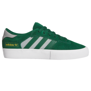 Green Adidas sneakers with white soles, featuring three grey stripes and the Adidas logo in yellow.