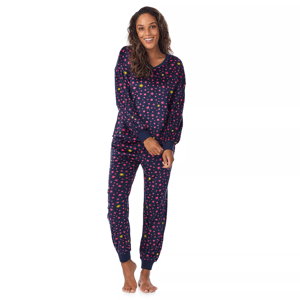 A woman is wearing a navy blue pajama set with colorful star patterns, featuring long sleeves and cuffed pants.