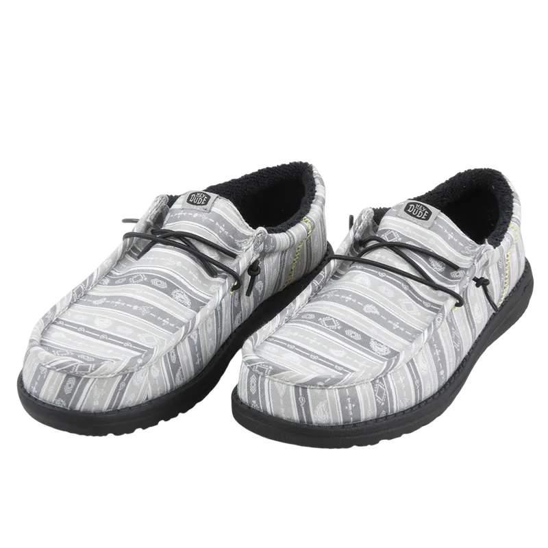 Gray slip-on shoes with black soles and patterned fabric design, featuring elastic laces and fur-lined interiors.