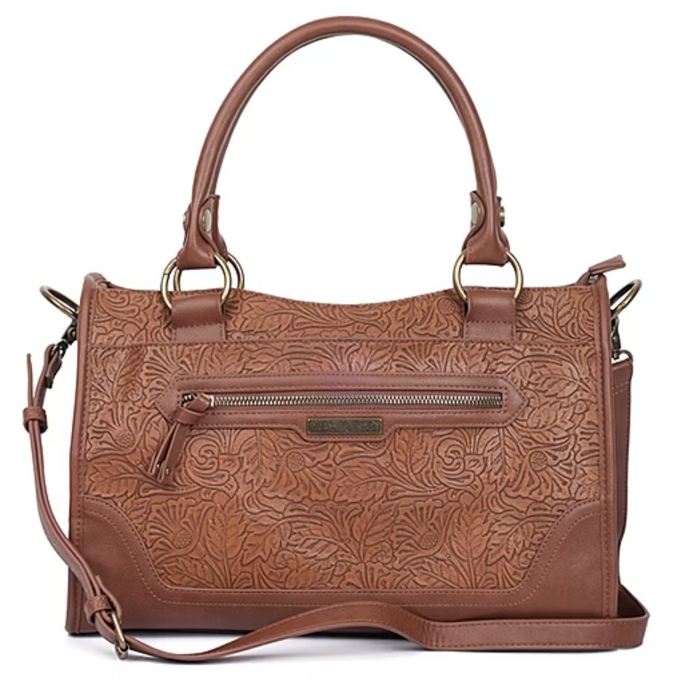 A brown leather handbag with floral embossing, featuring dual handles and an adjustable shoulder strap. It has a front zippered pocket with brass hardware accents.