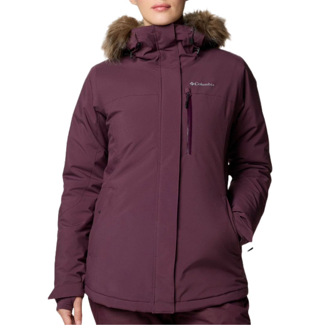 The Columbia Ava Alpine Insulated Jacket is a purple women's winter coat featuring a faux fur-trimmed hood and multiple pockets, designed for warmth and comfort in cold weather.