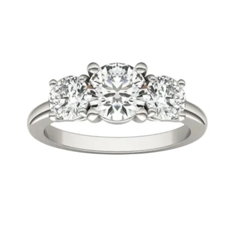 A three-stone engagement ring featuring a central round diamond flanked by two smaller round diamonds, set in a white metal band.